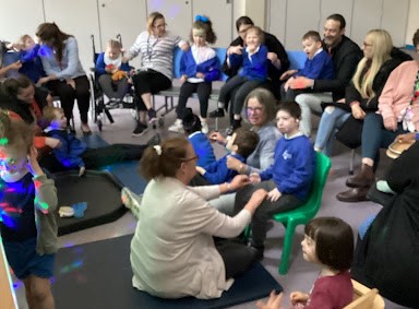 Students, parents and staff are seen interacting with one another in the classroom during a 'Share & Learn' afternoon at Milestone Academy.