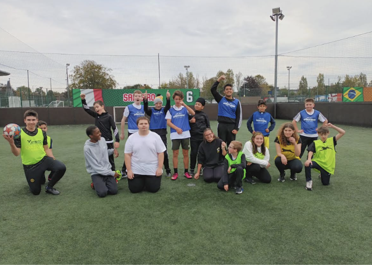 A team of Milestone Academy students are pictured posing for a group photo together at a sporting event they are participating in.