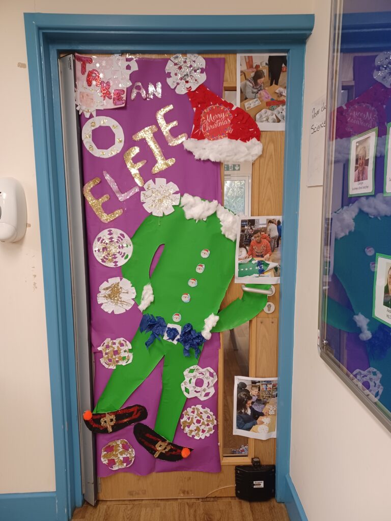 A photo of a Phase 4 classroom door which has been decorated for Christmas by students.