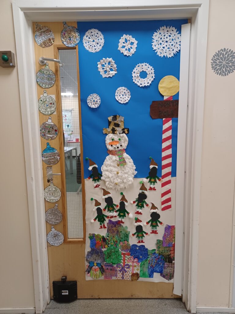 A photo of a Phase 4 classroom door which has been decorated for Christmas by students.