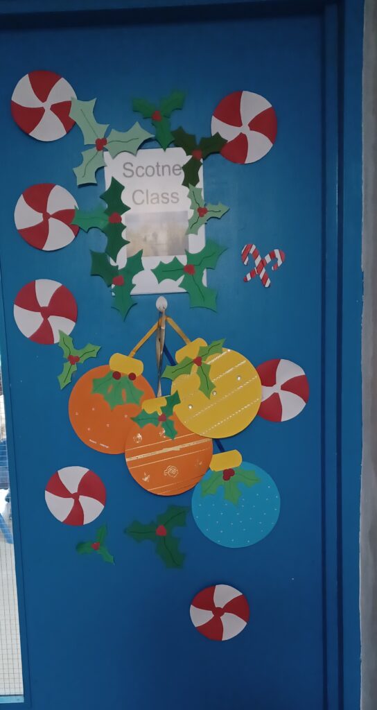 A photo of a Phase 4 classroom door which has been decorated for Christmas by students.