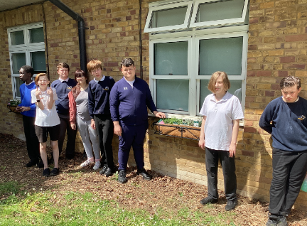 Students stood outside a planter