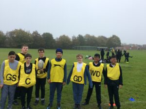 Students partaking in LAT tag rugby tournament in a grass field