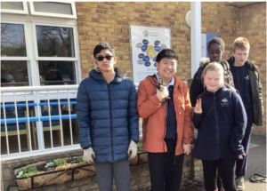 Students stood outside together with their planter